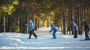 Kids skiing joyfully in the snow, showcasing winter fun and adventure.