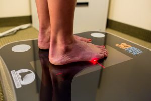 A modern foot scanner used in clinics to capture detailed 3D images of the feet for accurate assessment, pressure mapping, and custom orthotic design.